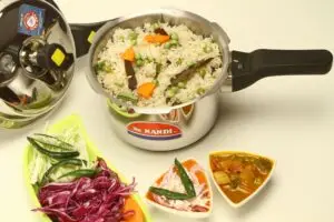 Indian vegetable pulao served with sides in a pressure cooker, showcasing vibrant flavors.