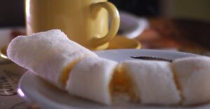 Warm coffee with Brazilian tapioca on a plate, perfect breakfast scene.